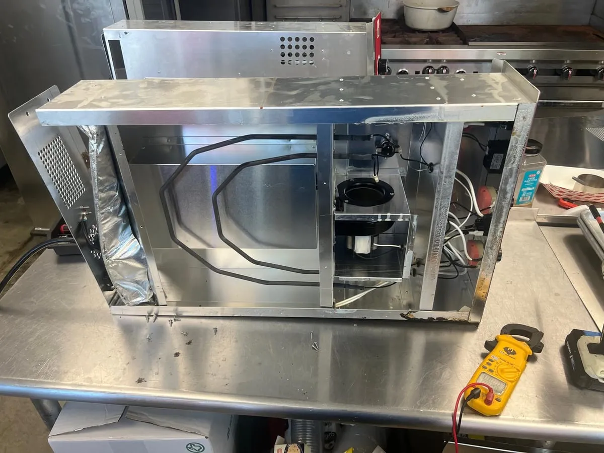 Commercial equipment on the bench, by an Optimal Appliance technician